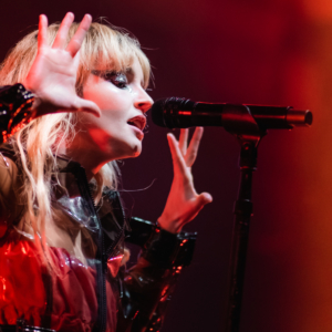 image of Lauren singing with her hand raised