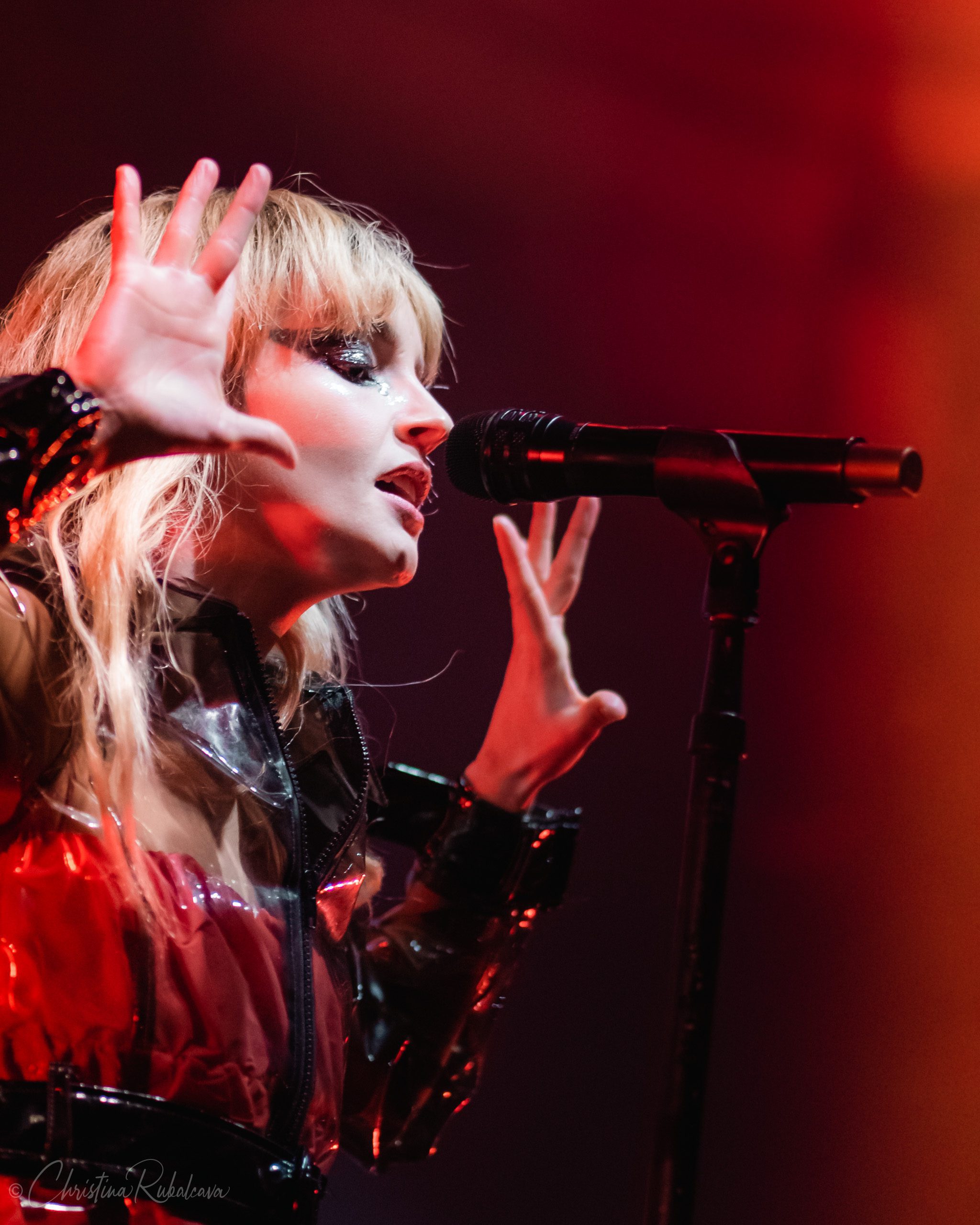 image of Lauren singing with her hand raised