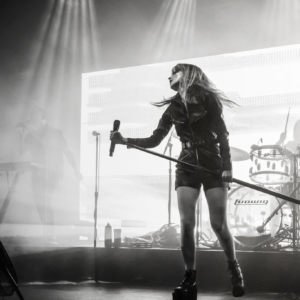 black and white image of Lauren holding a mic stand