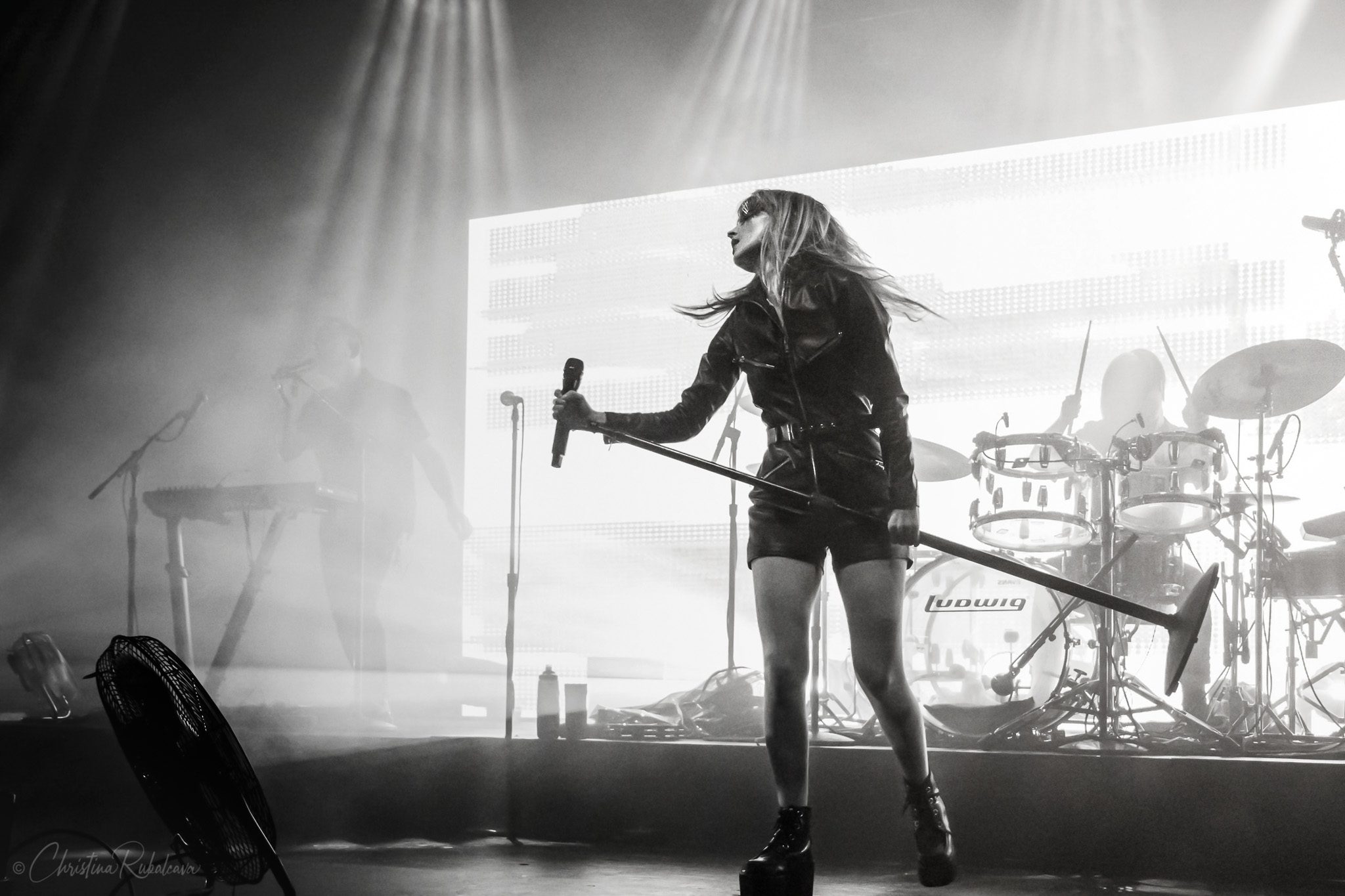 black and white image of Lauren holding a mic stand